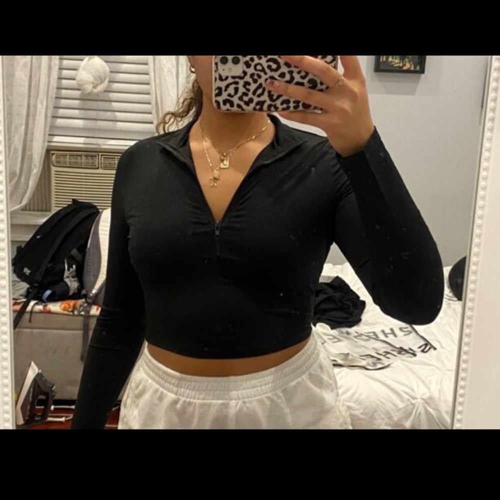 A black crop half zip up